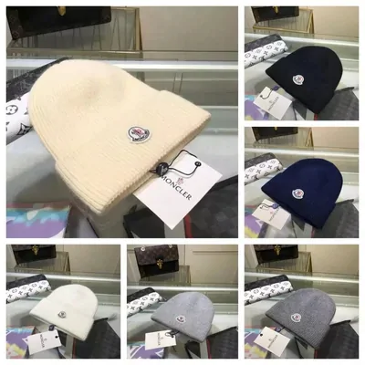 Gorro de punto beige con etiqueta y, al lado, varios gorros más en azul marino, gris y negro